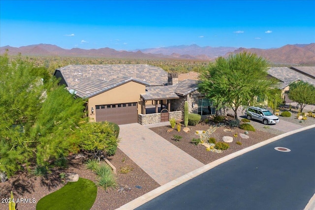 view of front of house with a mountain view and a garage