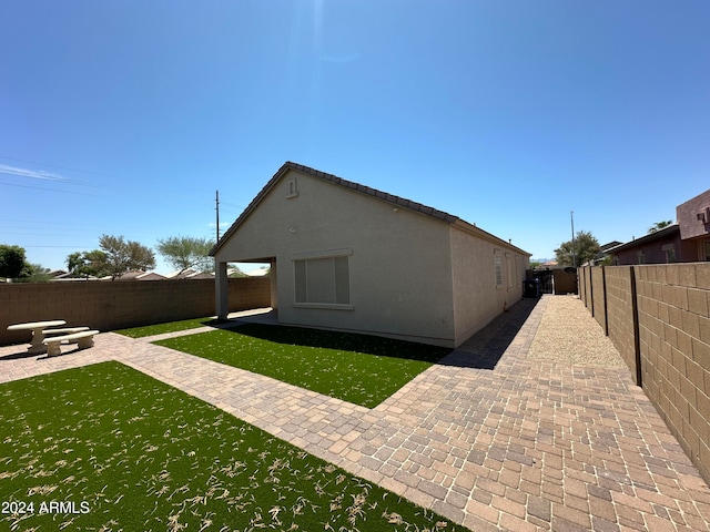 exterior space featuring a patio and a lawn