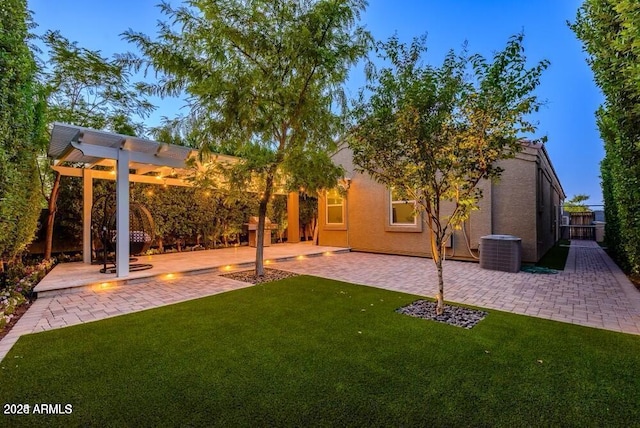 view of yard featuring central air condition unit, a pergola, and a patio