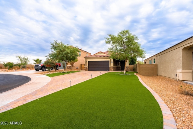 view of front of house featuring a tiled roof, decorative driveway, fence, and stucco siding