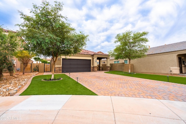 view of front facade with a garage, fence, a tiled roof, decorative driveway, and stucco siding