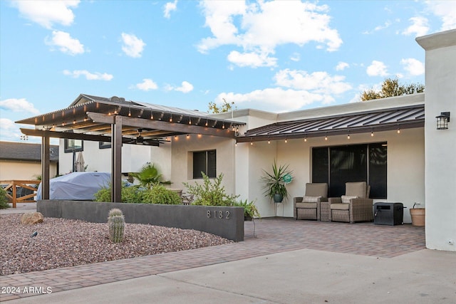 exterior space featuring a pergola, an outdoor hangout area, and a patio area