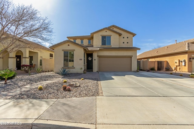 view of front of house with a tile roof, stucco siding, fence, a garage, and driveway