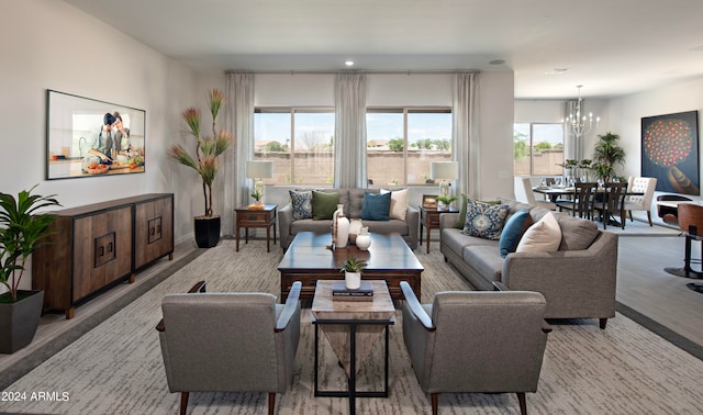 living room featuring an inviting chandelier and a healthy amount of sunlight