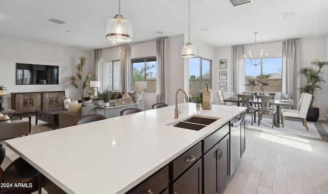 kitchen featuring a wealth of natural light, sink, and hanging light fixtures