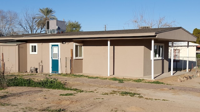725 E Hidalgo Ave, Phoenix, AZ 85040 - back of property with a shingled roof, stucco siding, and a shed