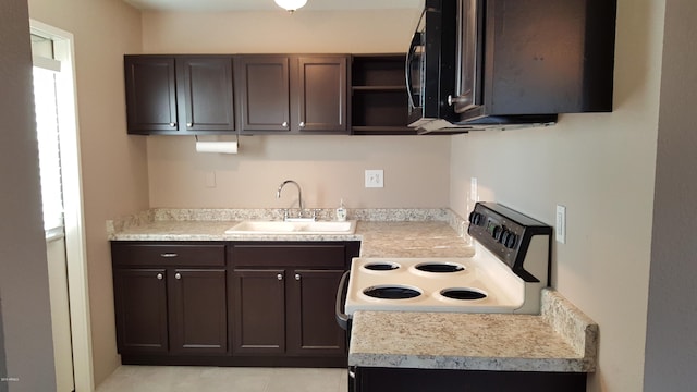 725 E Hidalgo Ave, Phoenix, AZ 85040 - kitchen featuring electric range, dark brown cabinets, and light countertops
