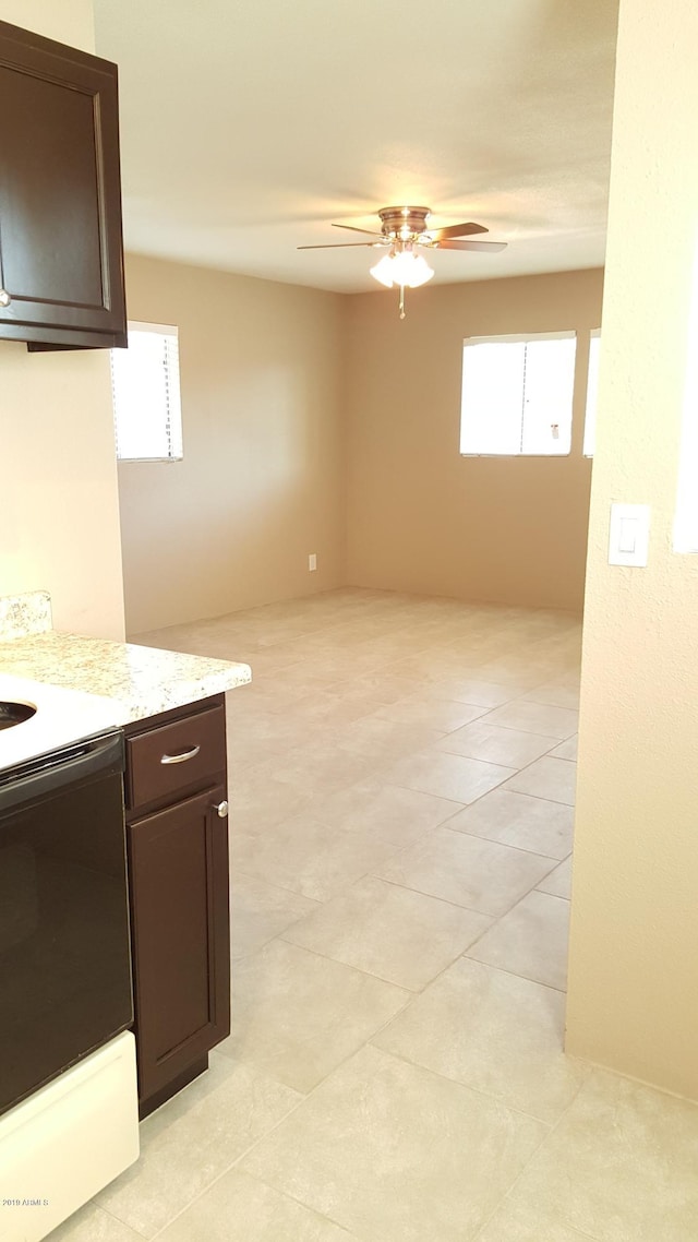 725 E Hidalgo Ave, Phoenix, AZ 85040 - kitchen featuring range, dark brown cabinetry, plenty of natural light, and a ceiling fan