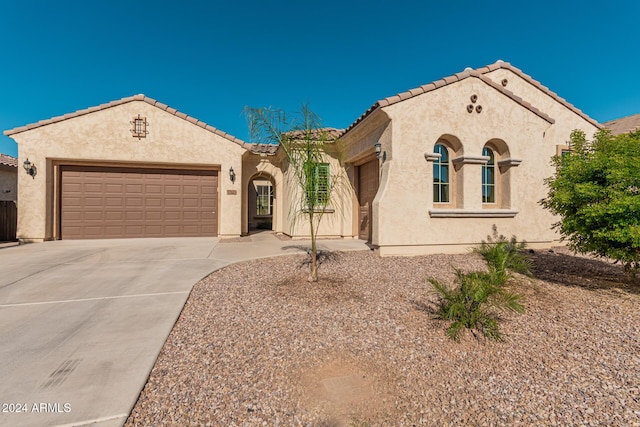 11122 E Tripoli Ave, Mesa, AZ 85212 - mediterranean / spanish-style house featuring stucco siding, an attached garage, and concrete driveway