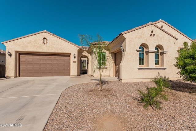 11122 E Tripoli Ave, Mesa, AZ 85212 - mediterranean / spanish house with an attached garage, a tiled roof, and stucco siding