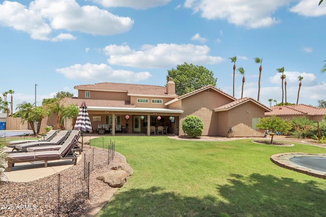 4735 E Harmony Cir, Mesa, AZ 85206 - back of property with stucco siding, a patio, and a lawn