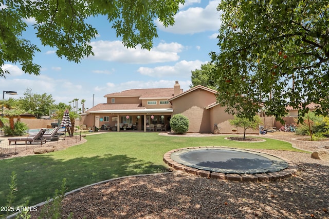 4735 E Harmony Cir, Mesa, AZ 85206 - rear view of house featuring a trampoline, stucco siding, a tiled roof, a patio, and a chimney