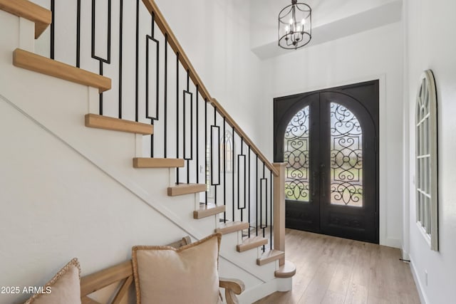 4735 E Harmony Cir, Mesa, AZ 85206 - entryway featuring french doors, wood finished floors, stairway, a chandelier, and a high ceiling