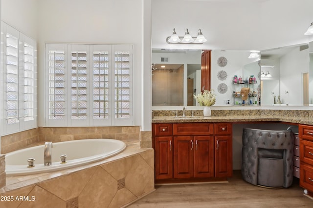 4735 E Harmony Cir, Mesa, AZ 85206 - bathroom featuring vanity, a bath, and wood finished floors