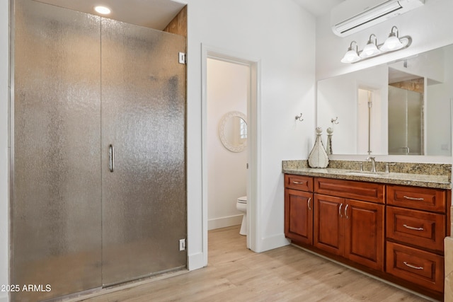 4735 E Harmony Cir, Mesa, AZ 85206 - bathroom featuring an AC wall unit, wood finished floors, vanity, and a shower stall