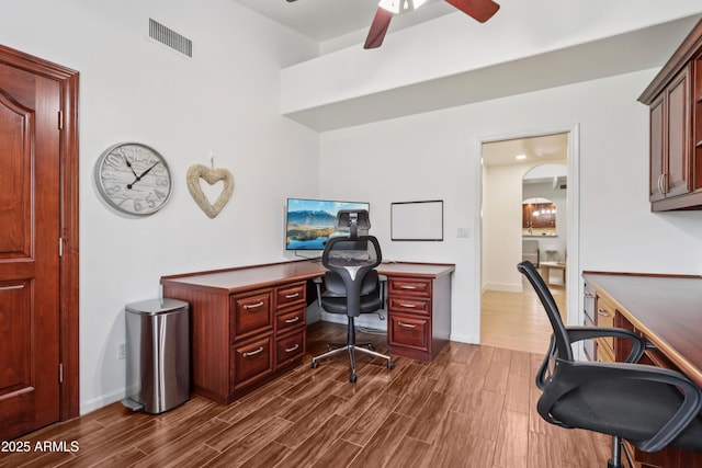 4735 E Harmony Cir, Mesa, AZ 85206 - office with dark wood-type flooring, ceiling fan, and arched walkways