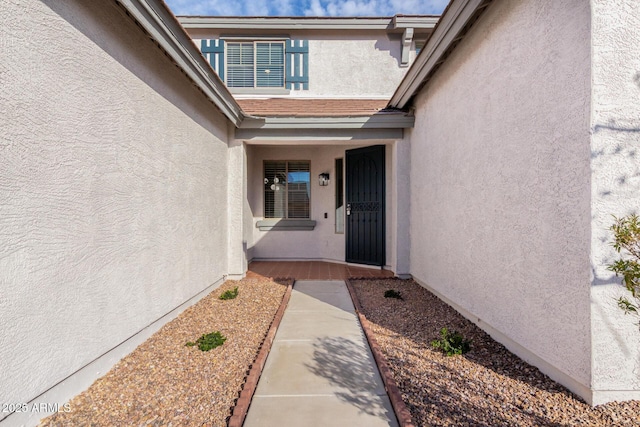 entrance to property with stucco siding