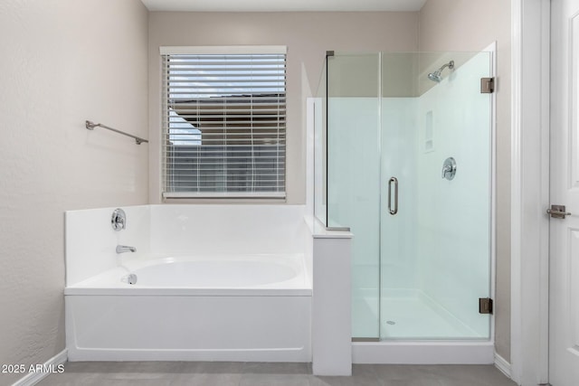 full bathroom featuring a stall shower and a bath