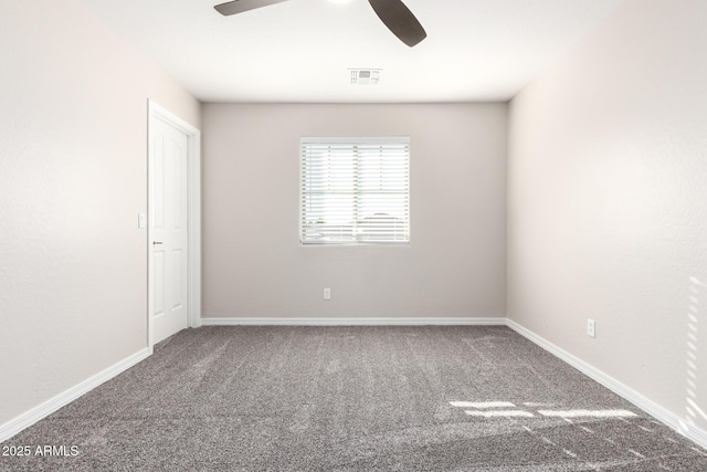 spare room featuring carpet, visible vents, ceiling fan, and baseboards