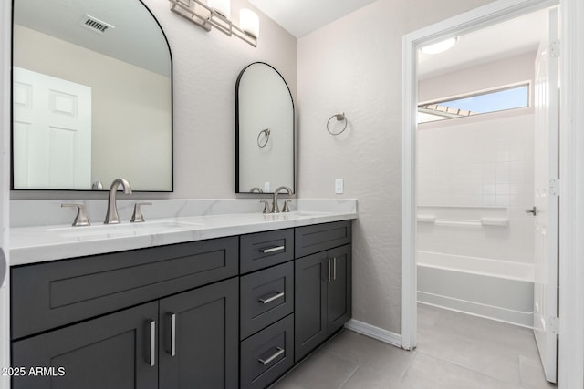 full bathroom with double vanity, tile patterned flooring, visible vents, and a sink