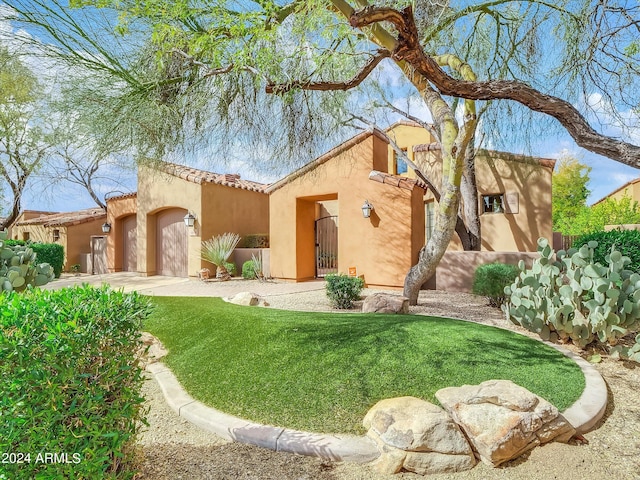 mediterranean / spanish home featuring a front yard