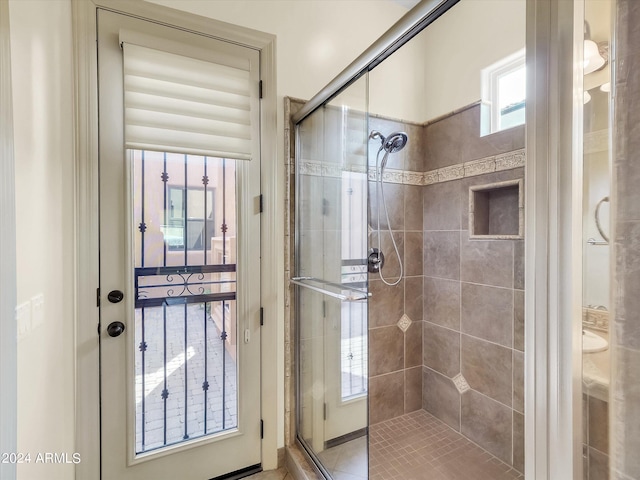 bathroom featuring a shower with shower door