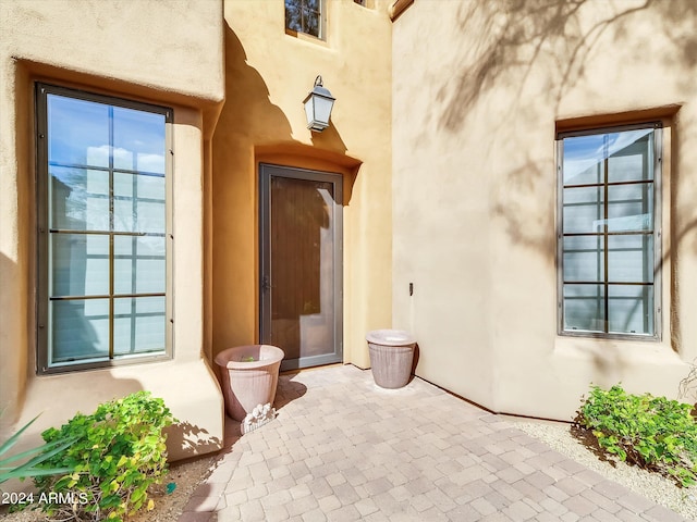 view of exterior entry featuring a patio