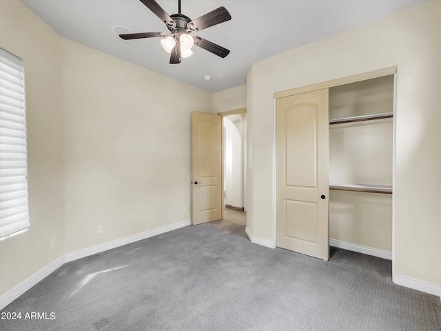 unfurnished bedroom with ceiling fan, carpet floors, and a closet