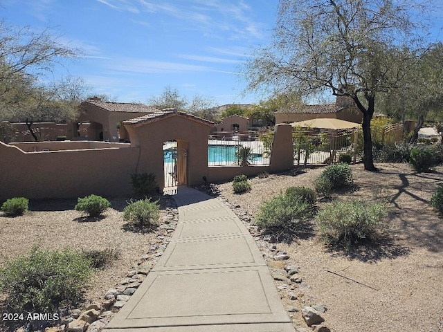 view of front of home with a fenced in pool