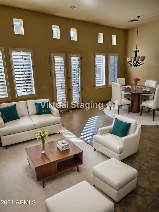 living room with tile patterned flooring, a wealth of natural light, and a notable chandelier