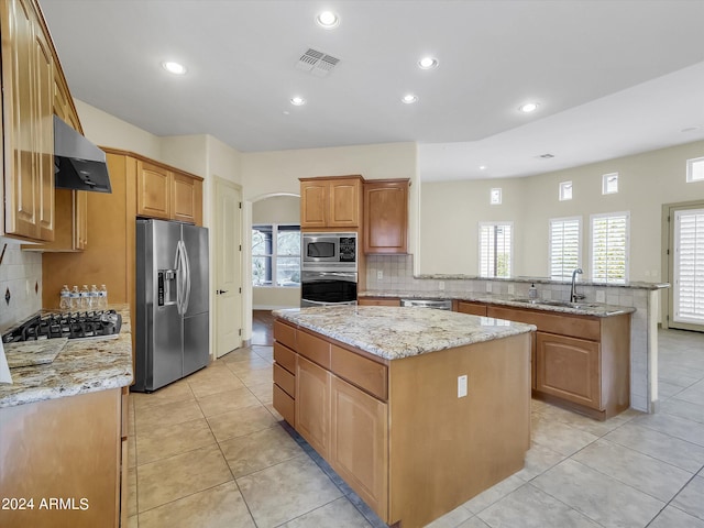 kitchen featuring light tile patterned flooring, a center island, ventilation hood, appliances with stainless steel finishes, and kitchen peninsula