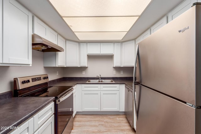 kitchen with white cabinetry, sink, appliances with stainless steel finishes, and light hardwood / wood-style flooring