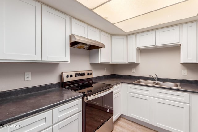 kitchen featuring white cabinetry, sink, and stainless steel electric range