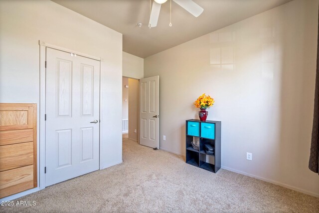 unfurnished bedroom with a ceiling fan, carpet, visible vents, and baseboards