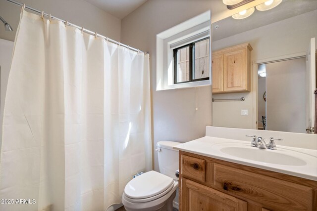 bathroom with a shower with shower curtain, toilet, and vanity