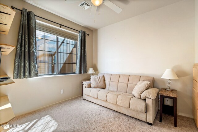 carpeted living room with visible vents, baseboards, and ceiling fan