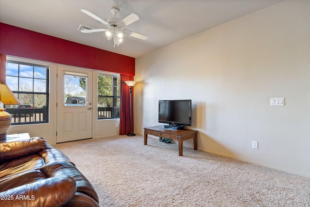 living room with baseboards, visible vents, carpet floors, and ceiling fan