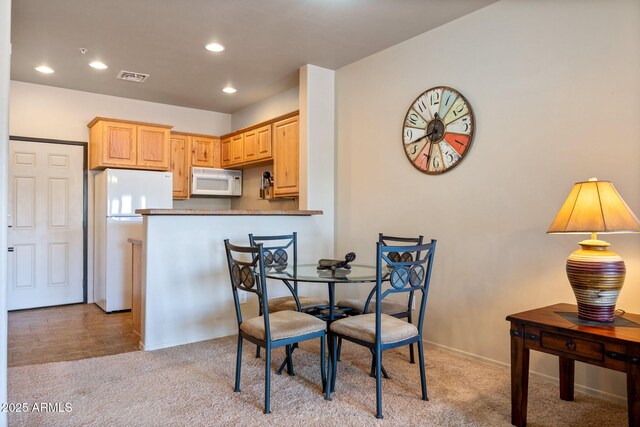 dining space featuring recessed lighting, visible vents, baseboards, and light colored carpet