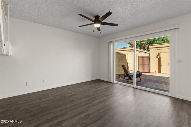unfurnished room featuring ceiling fan, a textured ceiling, baseboards, and dark wood finished floors
