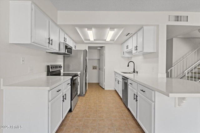kitchen with stainless steel appliances, visible vents, light countertops, and a sink