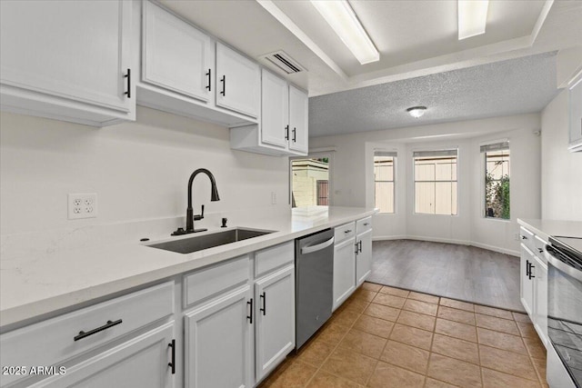 kitchen featuring appliances with stainless steel finishes, visible vents, a sink, and white cabinets