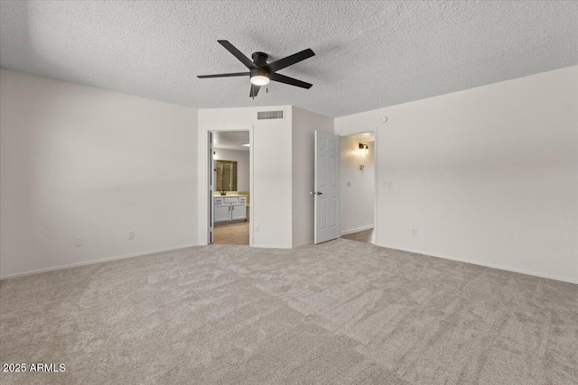 interior space with visible vents, ceiling fan, baseboards, and a textured ceiling