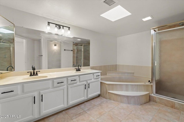 full bath featuring a stall shower, double vanity, a sink, and visible vents