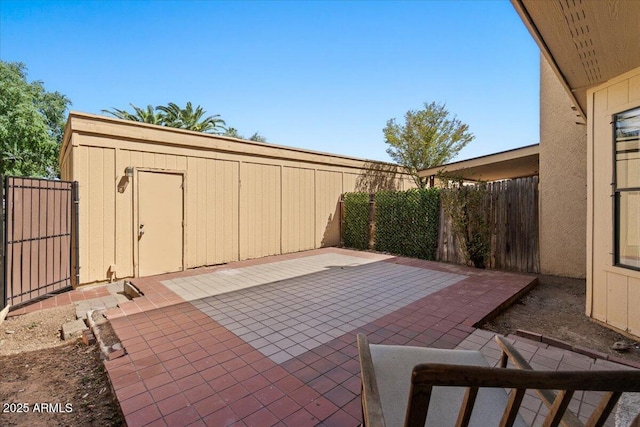view of patio / terrace with a fenced backyard and an outdoor structure