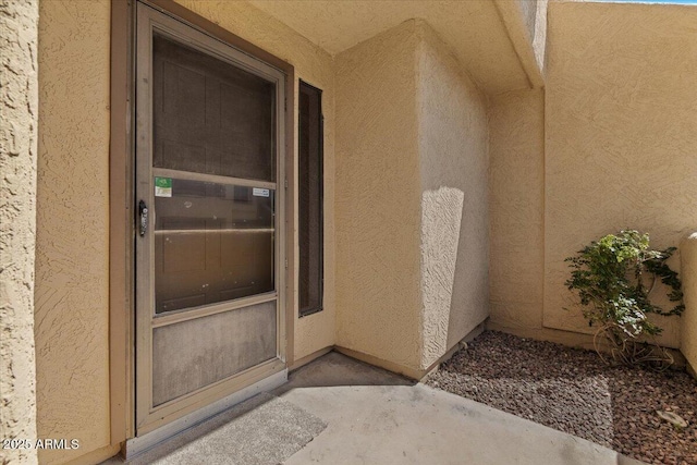entrance to property with stucco siding
