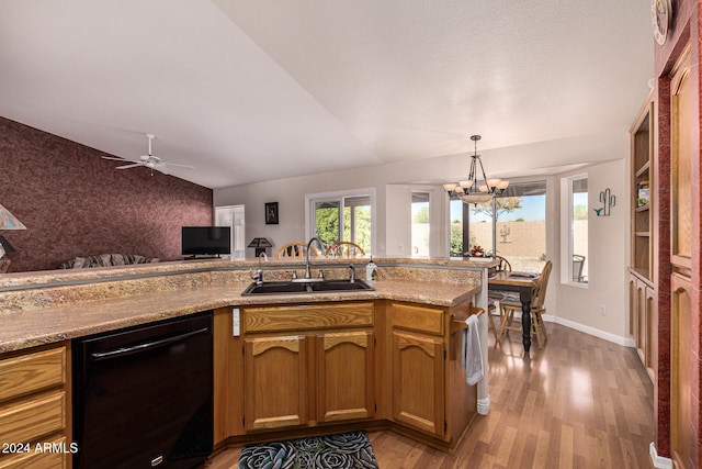 kitchen with ceiling fan with notable chandelier, sink, light hardwood / wood-style flooring, dishwasher, and hanging light fixtures