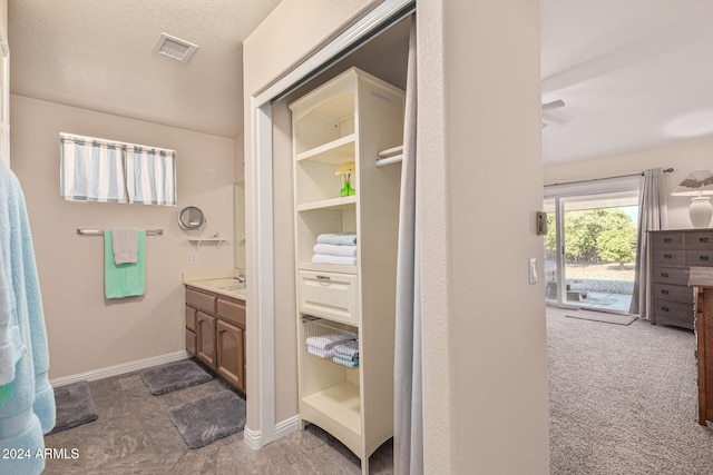 bathroom with a textured ceiling and vanity