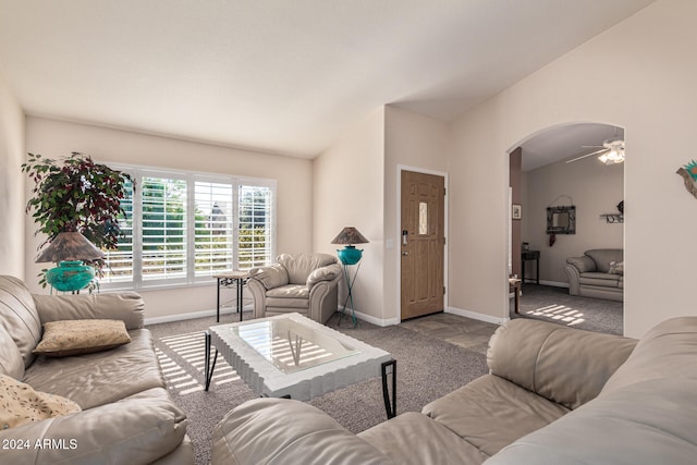 living room featuring carpet floors, ceiling fan, and lofted ceiling