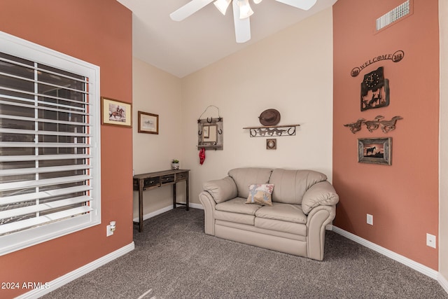 living room with carpet flooring, vaulted ceiling, and ceiling fan