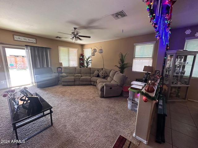 living room featuring carpet and ceiling fan